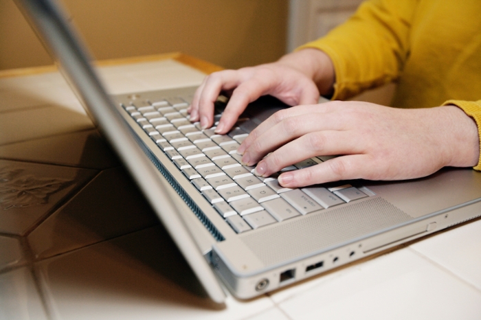 student at laptop computer